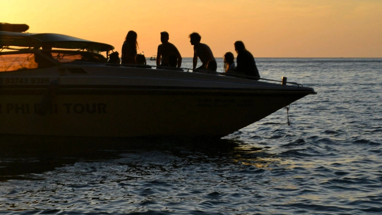 Group of people on a boat tour in Antalya with scenic coastlin